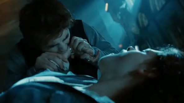 Still from Twilight: Edward sucking venom out of Bella&#x27;s wrist as she lies on the floor