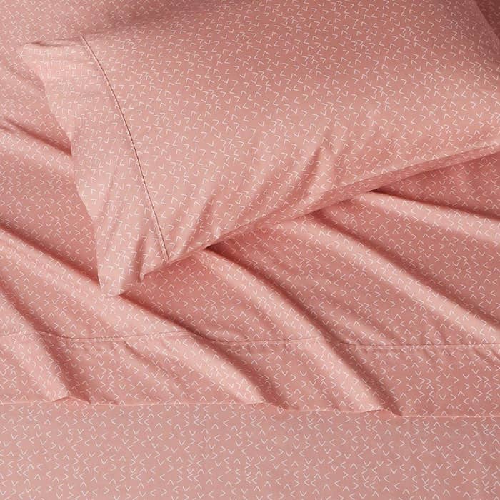 The flat sheet and pillowcase on a bed