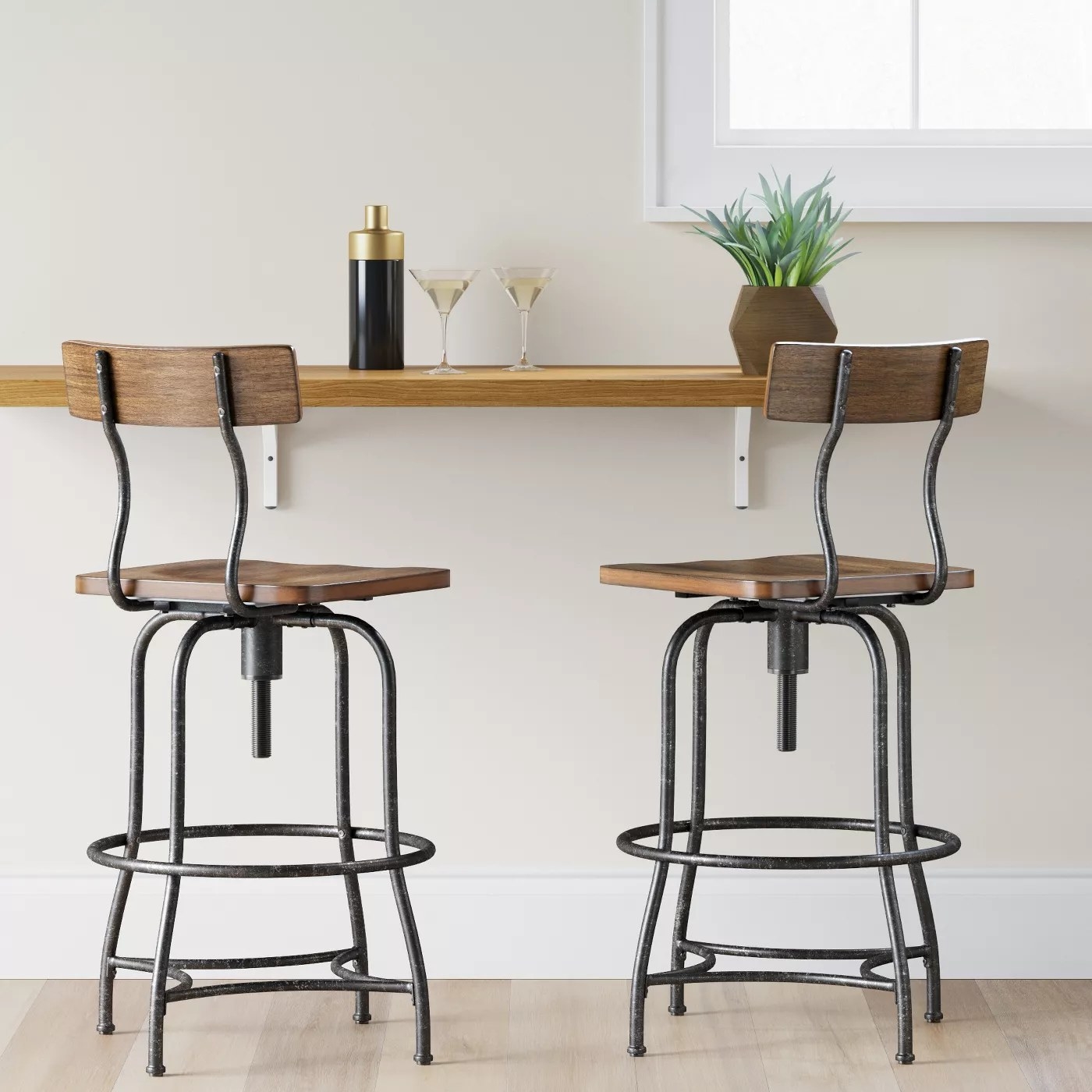 the bar stool with a brown seat and black legs