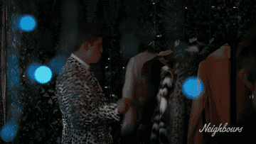 Man dancing provocatively with a inanimate coat.