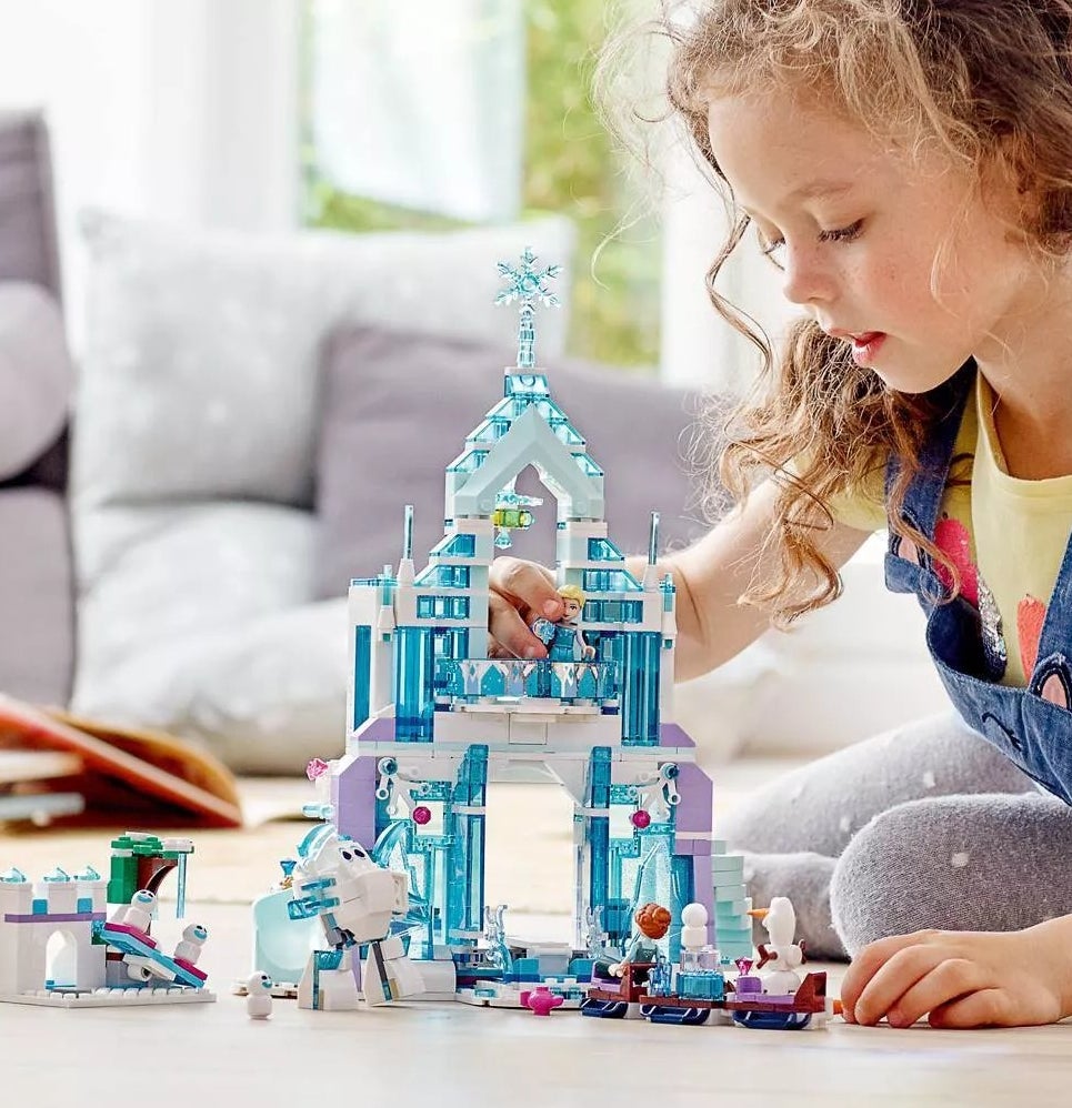 A child playing with a &quot;Frozen&quot; castle