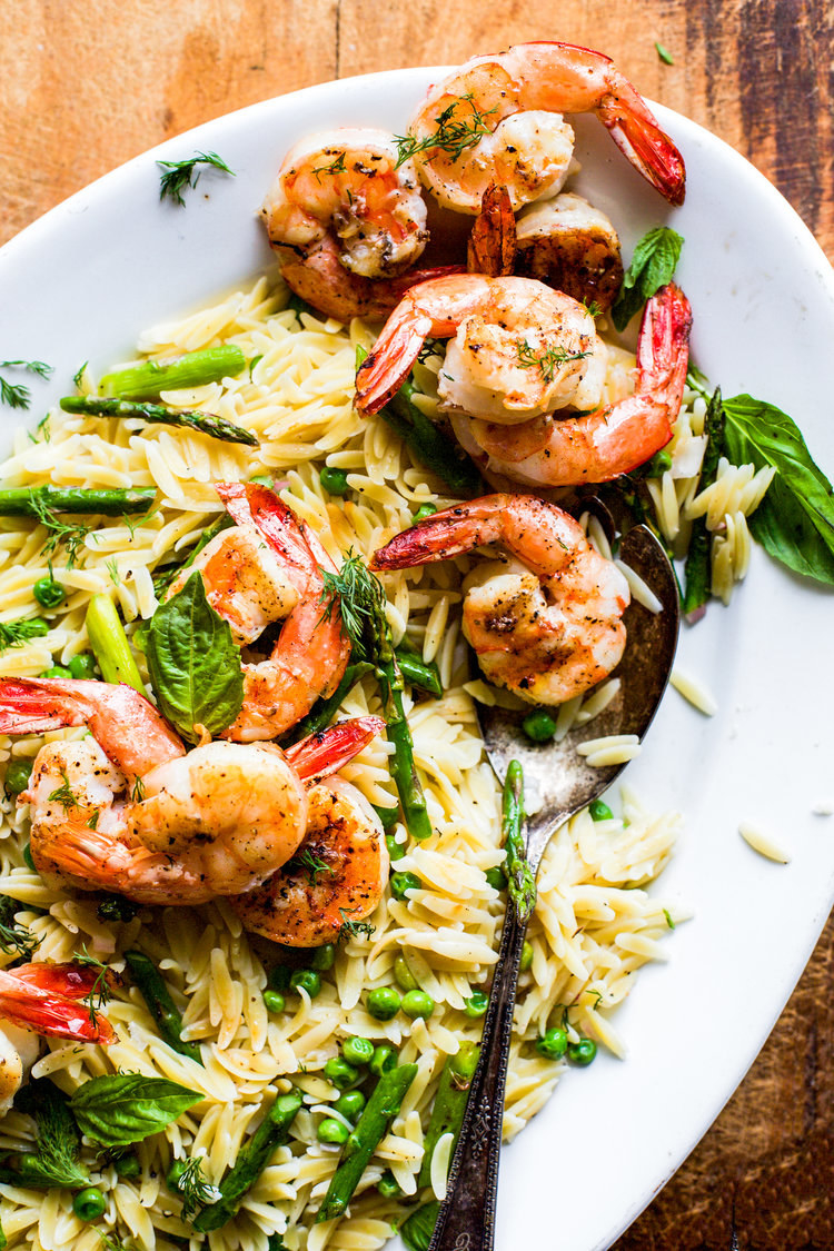 A big platter of orzo with asparagus, peas, and grilled shrimp.