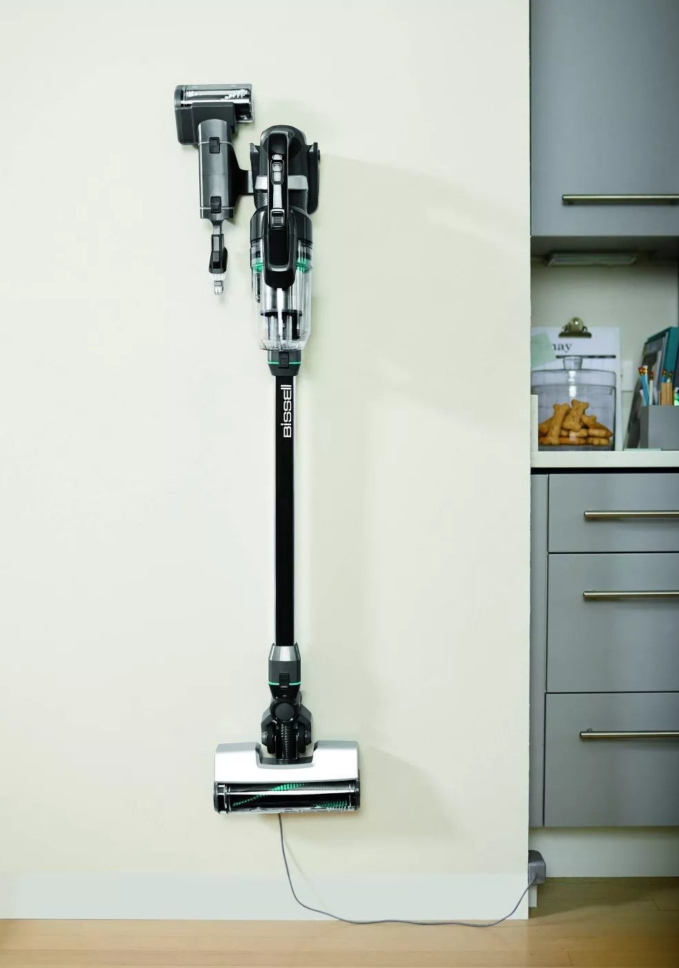 A stick vacuum mounted on a wall