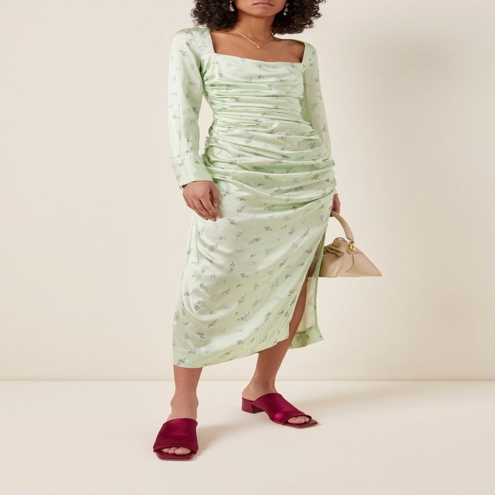 Model wearing the light green silk dess