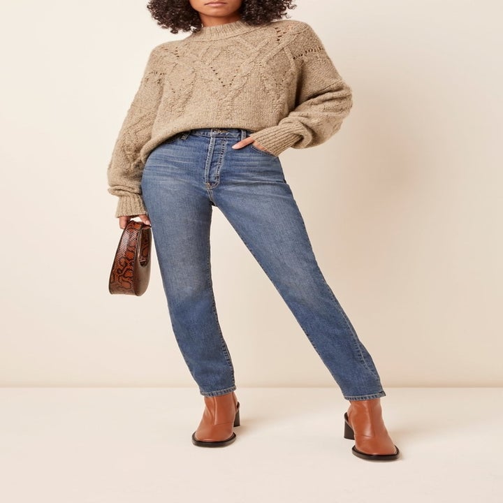 model wearing high-rise blue jeans 