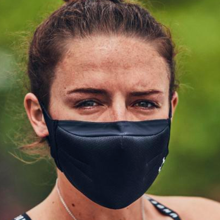 A close up of a person wearing the face mask