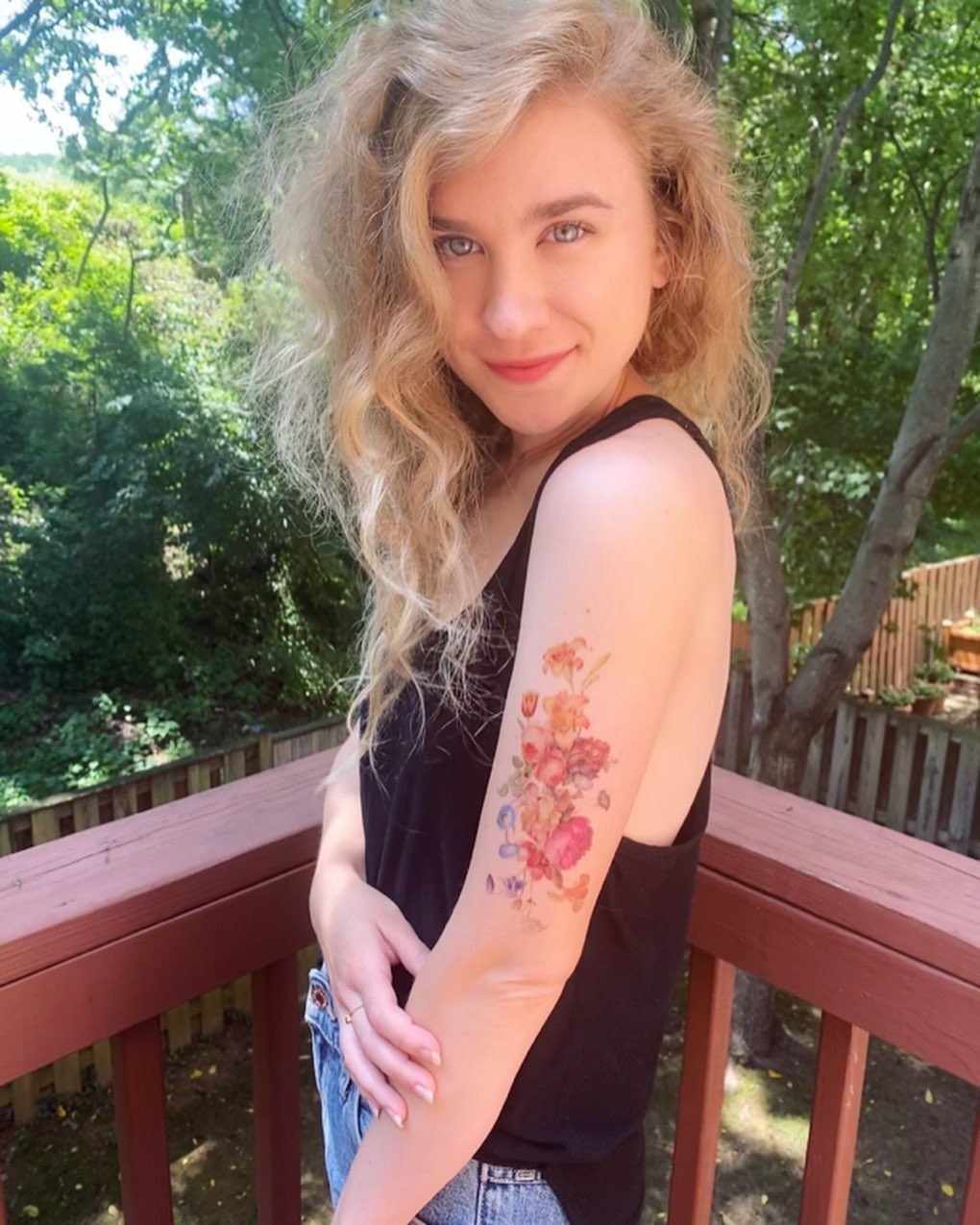 BuzzFeed editor with a floral temporary tattoo on their upper arm