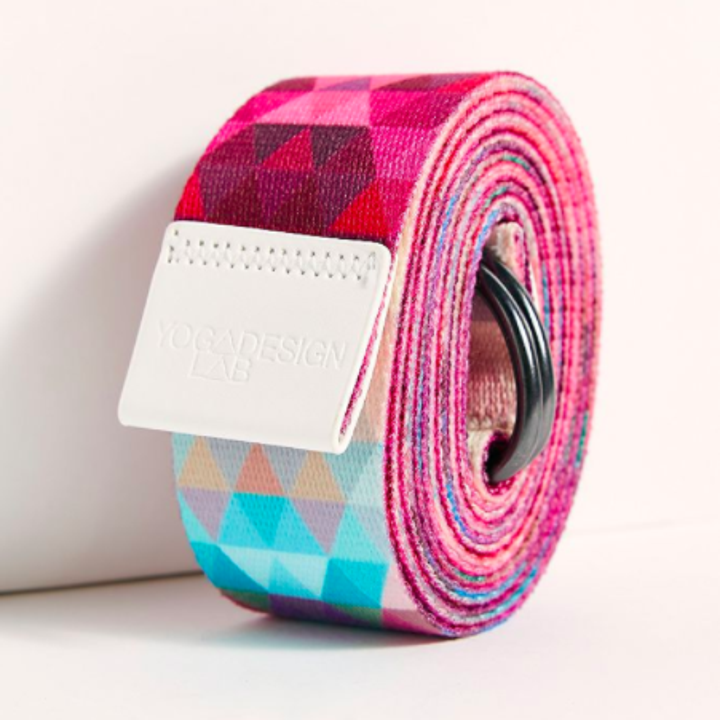 The yoga strap neatly wrapped into a tidy roll