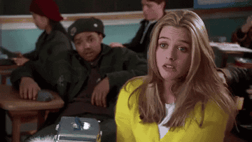 Elton endearingly massaging Cher&#x27;s shoulders during homeroom in &quot;Clueless.&quot; 