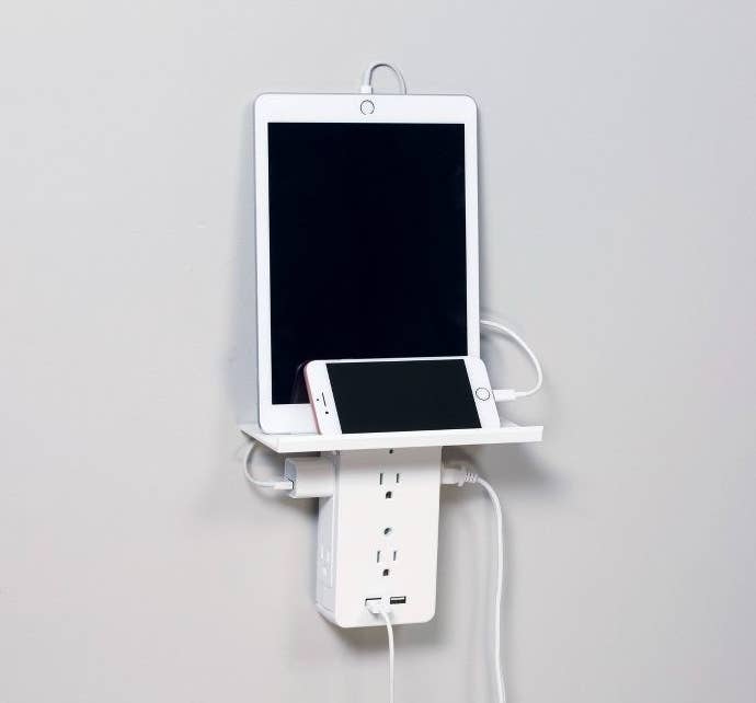 socket shelf with ipad and iphone on top