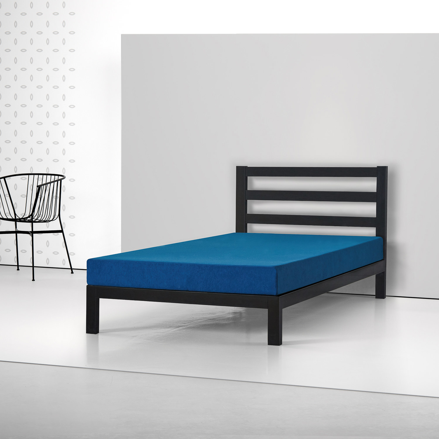 The blue mattress on a black metal bed frame