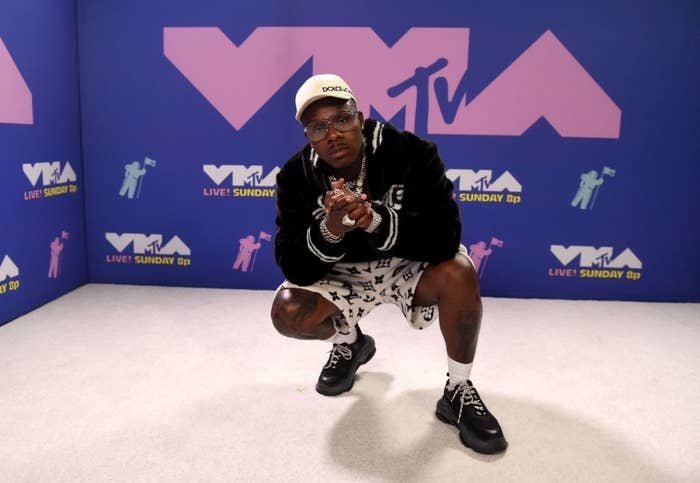 DaBaby crouches down in a pose at the VMAs