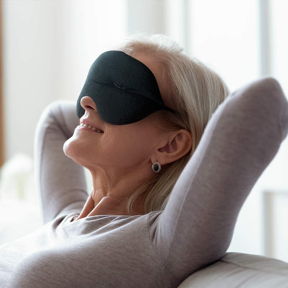 A model wearing the puffy black fabric eye mask