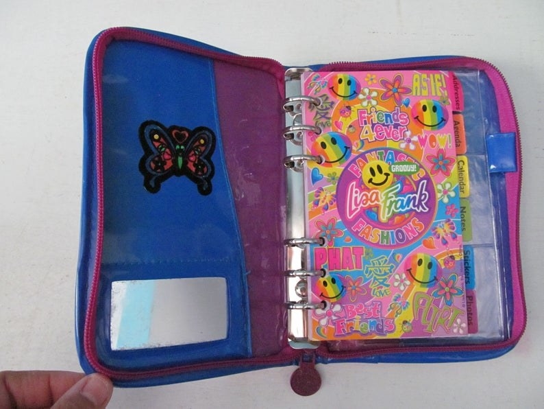 A pink, blue, and purple Lisa Frank day planner