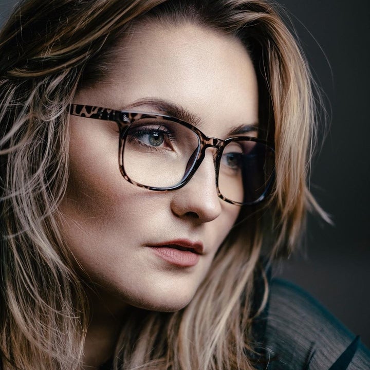 A person looks moodily off camera while wearing the glasses
