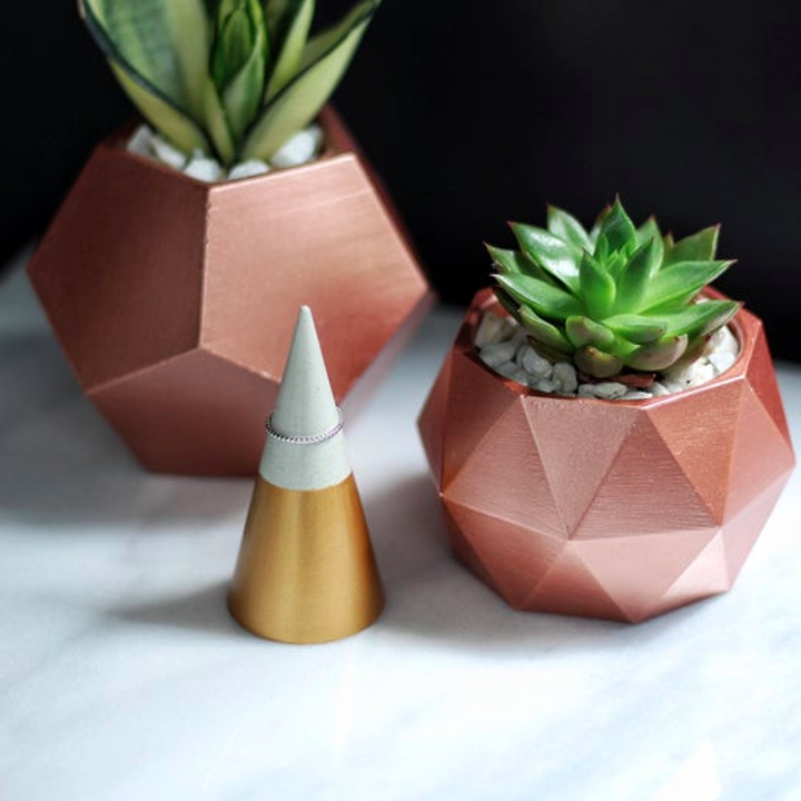 A single ring cone next to modular cement planters  