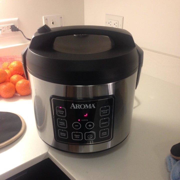 reviewer's rice cooker with silver body, some buttons, and a black top