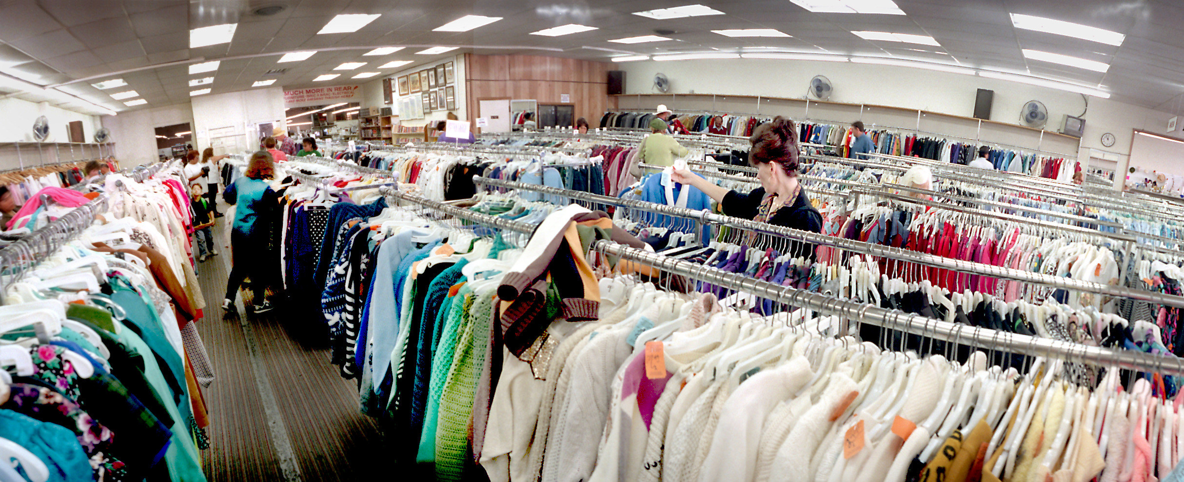 A wide-angle shot of a brightly lit thrift store in the &#x27;90s