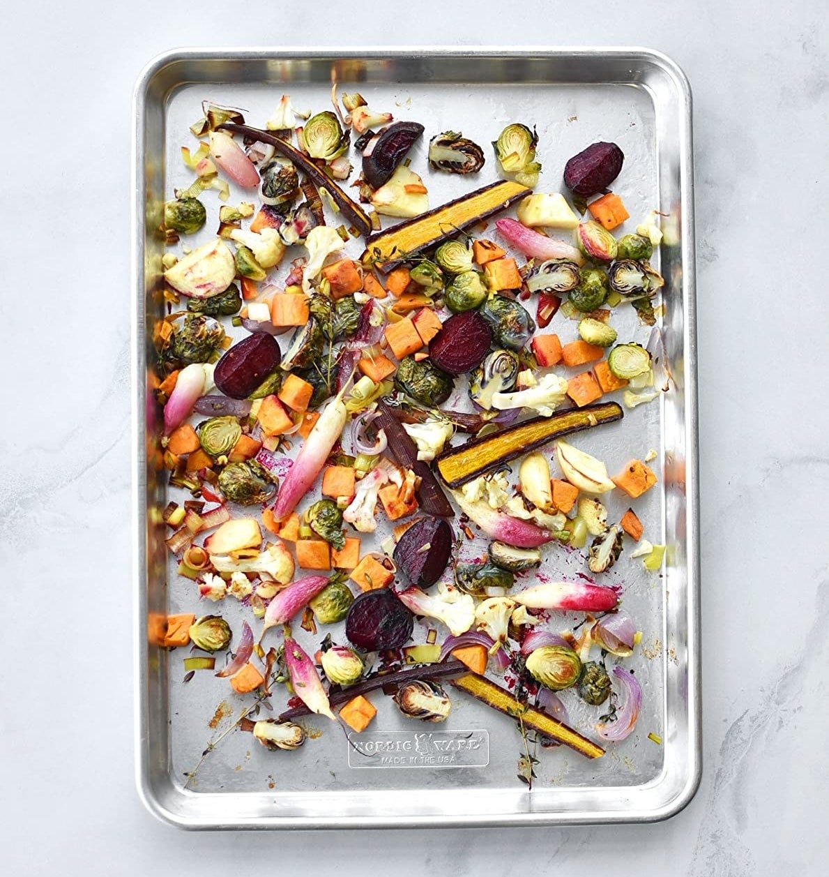 silver sheet tray of roasted mixed vegetables