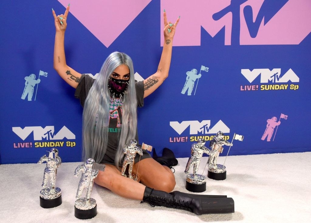 Gaga posing in a face mask with five VMAs