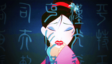 A gif from Mulan showing Mulan wiping her makeup off in front of a mirror with Chinese letters on it