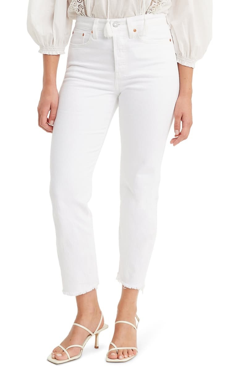 Model wearing Levi&#x27;s wedgie high waist raw hem white cropped jeans 