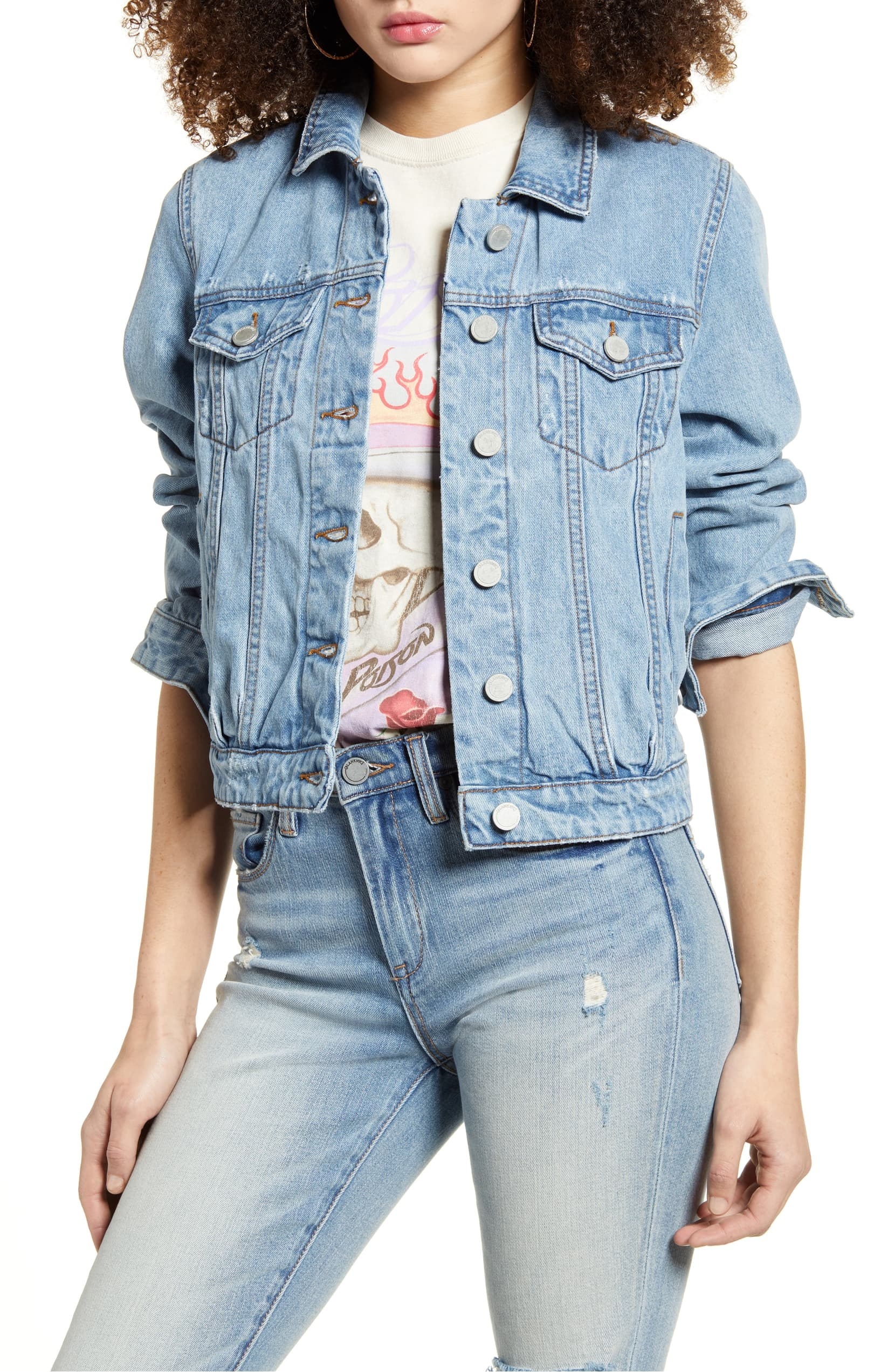Model wearing BLANKNYC distressed denim jacket with jeans and a graphic tee