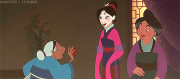 A gif from Mulan showing Mulan&#x27;s grandmother reaching up and shoving an apple in Mulan&#x27;s mouth who looks surprised