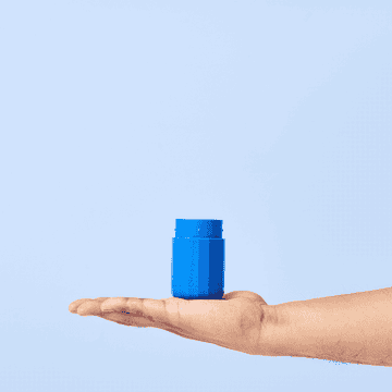 A GIF of hands refilling the bright blue case with deodorant