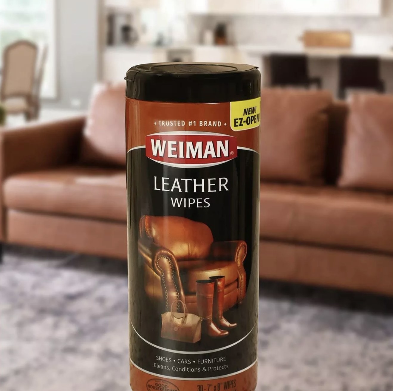 Black container that says "Weiman Leather Wipes" next to a brown couch