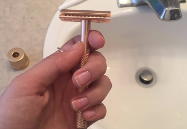 A reviewer holding up the razor 
