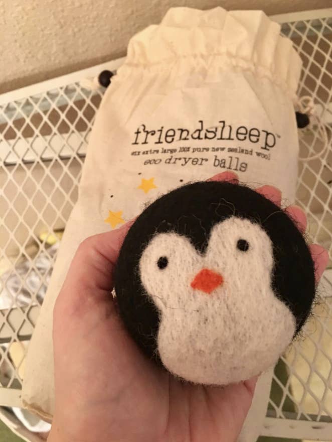 A reviewer image of a penguin shaped dryer ball 