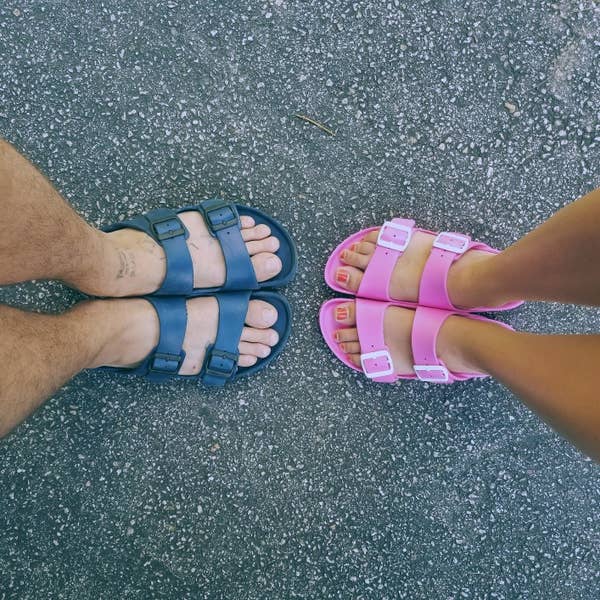 two reviewers's pairs of feet: one in blue, the other in pink Birkenstocks