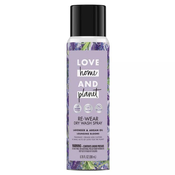 Clear bottle with florals that says "Love Home And Planet Re-Wear Dry Wash Spray"