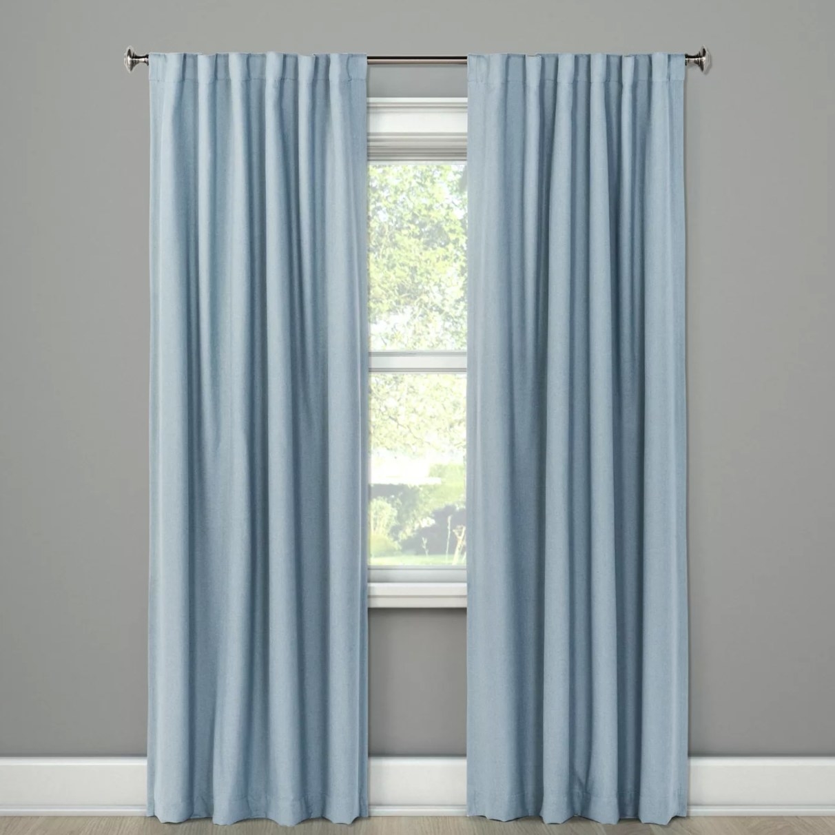 The blue curtains on a window 