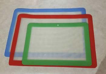 reviewer image of three mats, one lined in blue, another in red, and another in green 