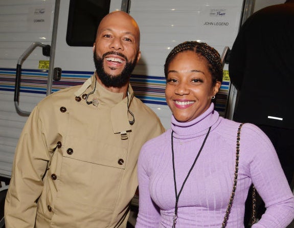 Common and Tiffany Haddish smiling together on set