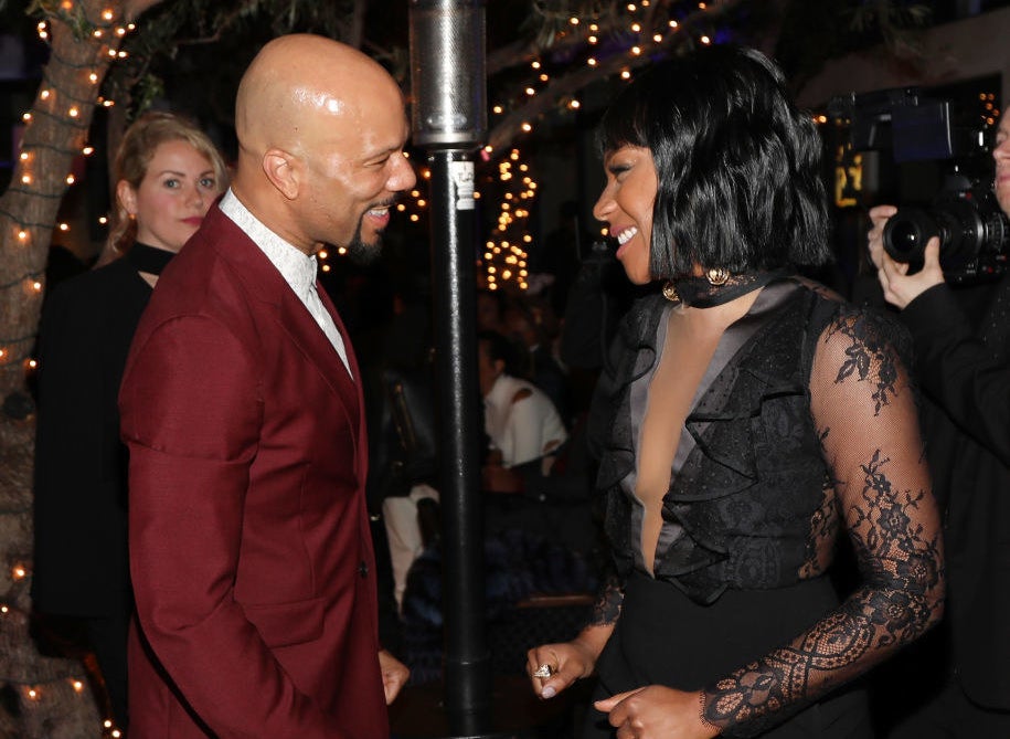 Common and Tiffany Haddish smiling at each other