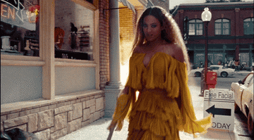 Beyoncé swinging a bat with an explosion behind her