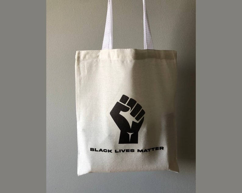 A tote with a fist that says black lives matter