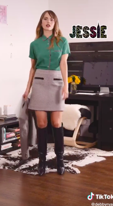 Debby as Jessie in blouse, knee-high skirt, and boots