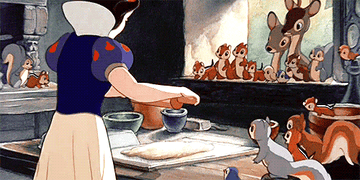 Snow White kneading bread as her animal friends watch.