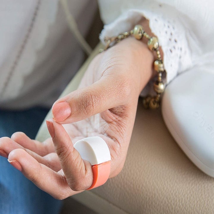 A person wearing the meditation ring on their pointer finger.