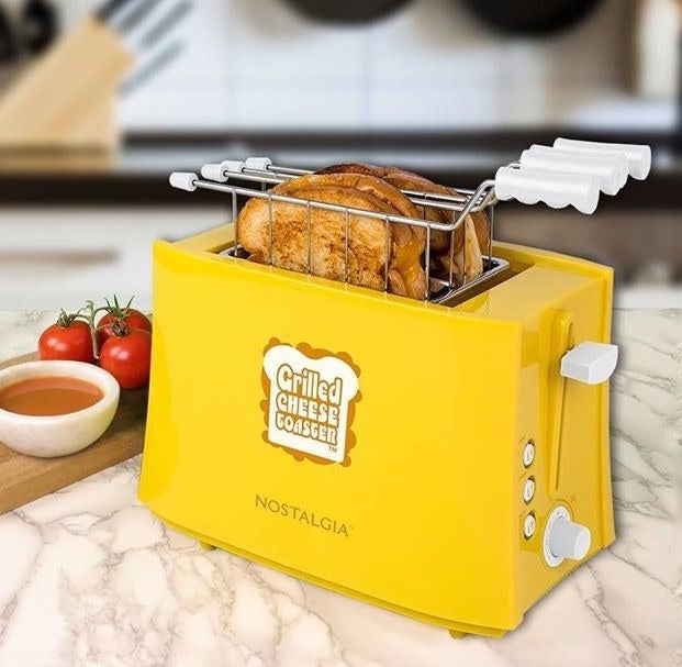 The toaster with two grilled cheese sandwiches inside