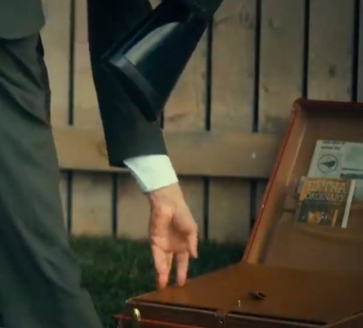 A briefcase with newspaper with the sparrow logo in it inside.