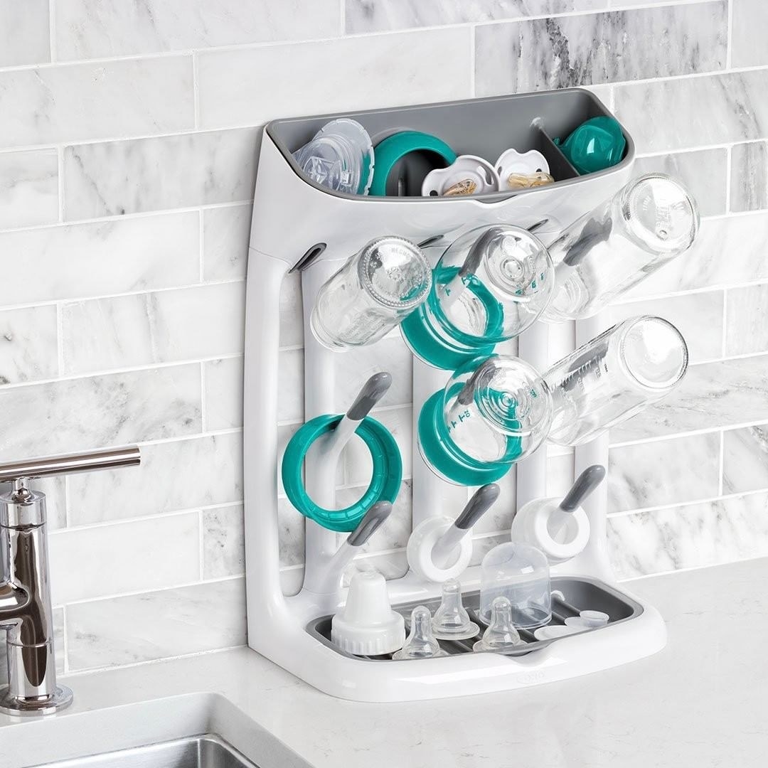 The bottle rack laden with caps lids and bottles perched on a countertop