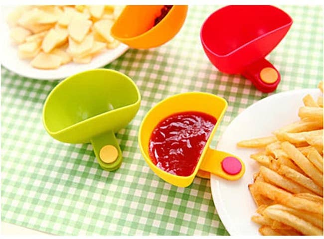 The dip clip filled with ketchup and attached to a plate of french fries