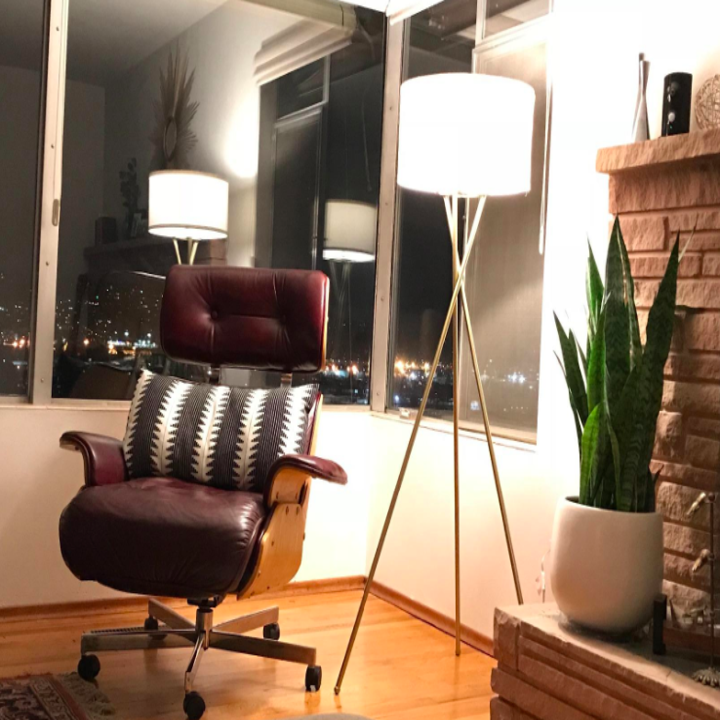 A customer review photos of the Jaxon Tripod LED Floor lamp in the corner of someone's home