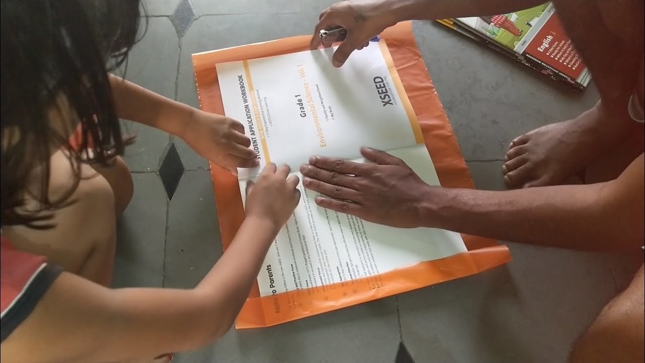 Image of people covering their school books with brown paper.