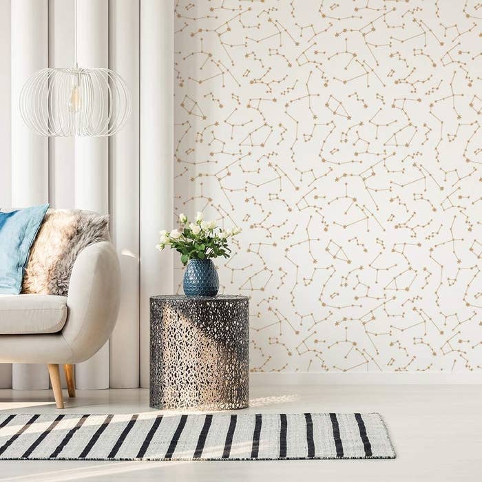 A living room with one wall covered in the wallpaper in Frost